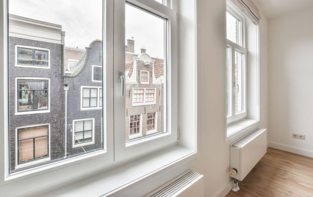 Interior view of modern white vinyl windows in an Edmonton home, illustrating signs that it may be time to replace aging windows.