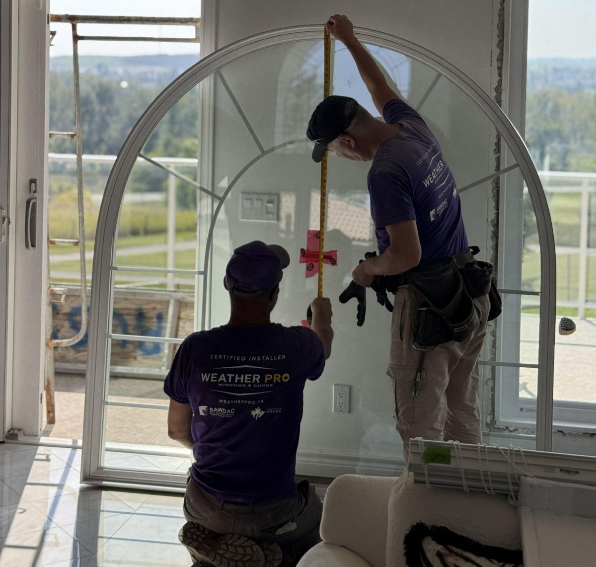 Weather Pro window replacement measurement and installation Weather Pro installers measuring a window for replacement